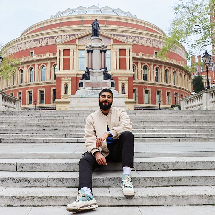 Haaris sitting on the steps outside Royal Albert Hall